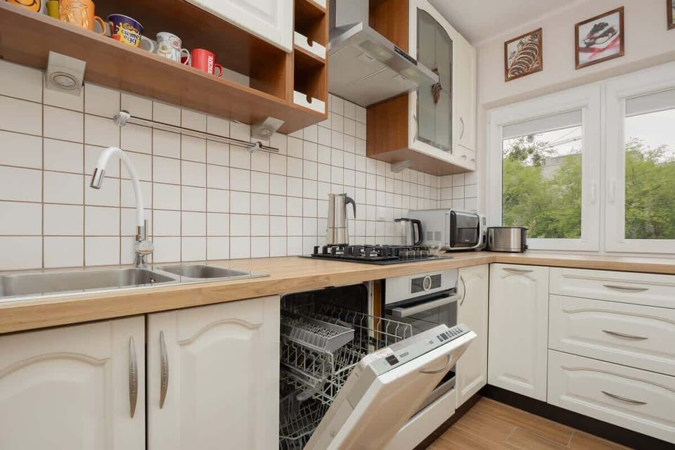 FUnkitional kitchen with bright cabinets and high quality appliances.