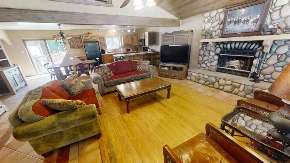 Picture yourself here: open-plan living meets rustic charm, with exposed beams overhead and a stunning stone fireplace as your cozy centerpiece. This cabin-style retreat combines comfort, character, and mountain warmth in every detail.