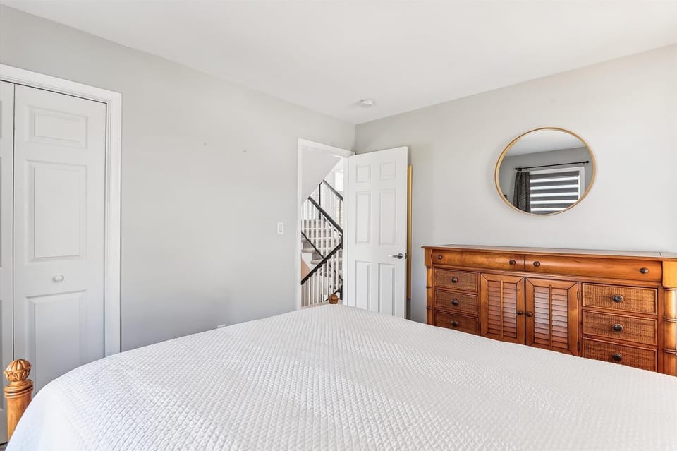 Slip into crisp linens and drift off in this serene bedroom, where minimalist design meets thoughtful comfort. Natural light fills the space, warm wood accents add character, and your peaceful retreat awaits.