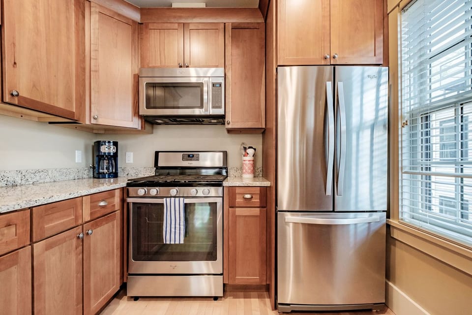 cherry wood kitchen with granite and stainless appliances