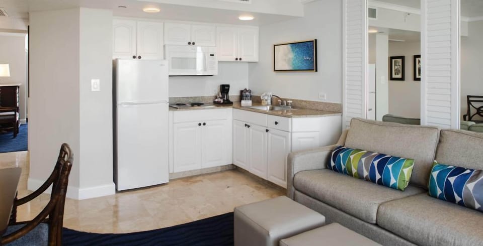 Lounge in comfort while city views glow beyond the balcony.