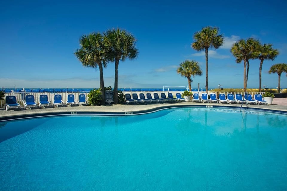 Dive into the expansive pool with breezy ocean backdrop.
