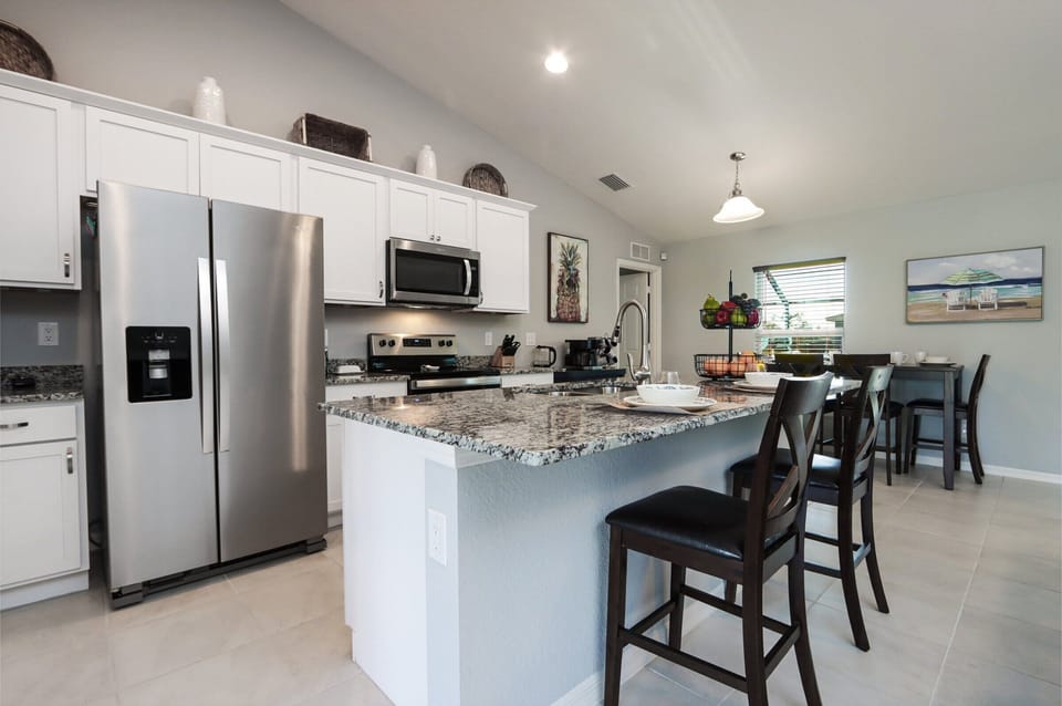 Open-concept kitchen designed for cooking and socializing, complete with stainless steel appliances