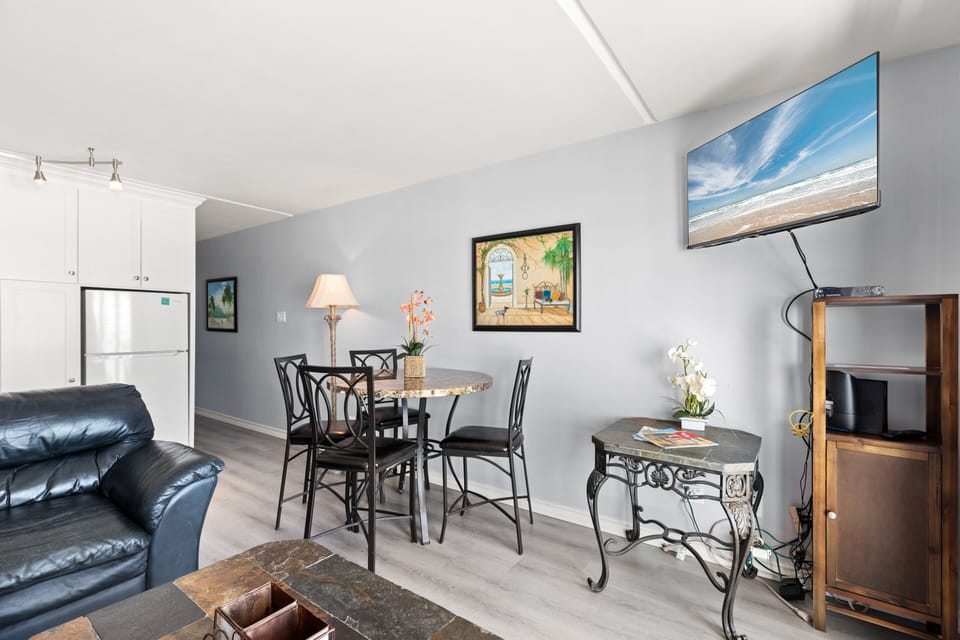 Open concept Living and Dining area surround a Flat Screen TV