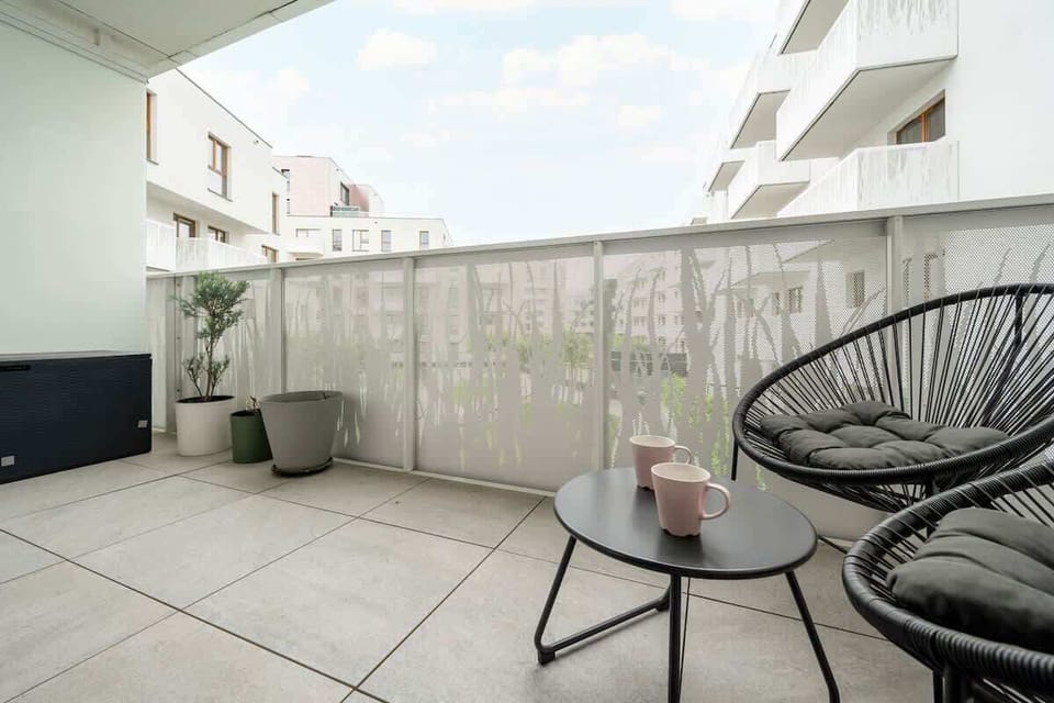 The furnished balcony offers a perfect spot for morning coffee.