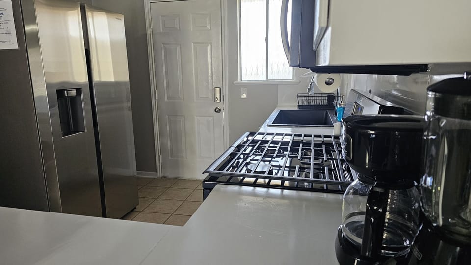 Experience the pleasure of home cooking in our inviting kitchen, furnished with everything you need for culinary adventures.