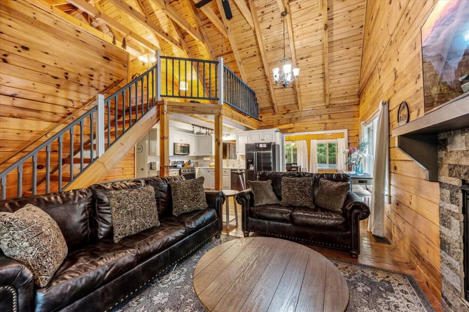 The living room has high ceilings, beautiful decor, and plenty of comfortable seating.