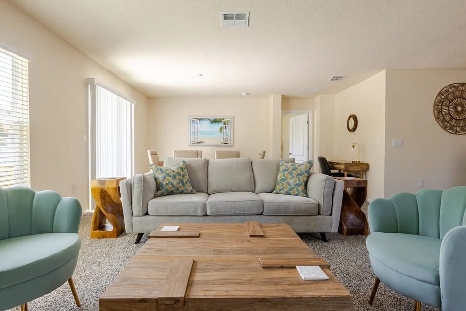 Open concept living room is elegantly furnished.