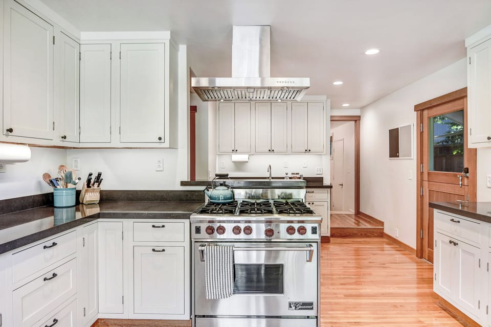 Chef's kitchen (w/ 6-burner Wolf range) offers an inviting space for meal prep!