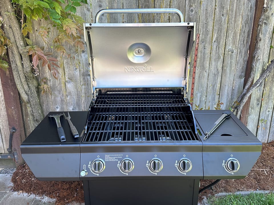 Outdoor gas BBQ has 4 burners, as well as a separate side burner. 