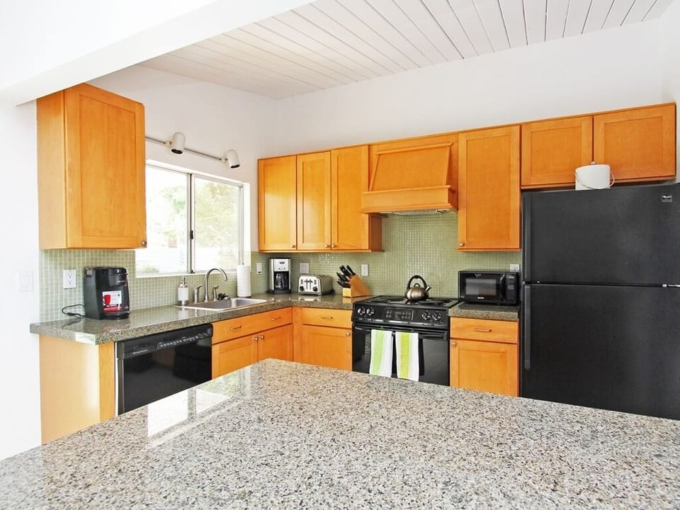 Well stocked kitchen open to the living room with large island.