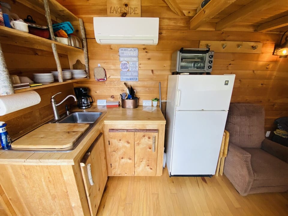 Experience the inviting charm of an open and cozy floor plan that effortlessly connects the kitchen and living area, where you can savor breathtaking views of the lake.