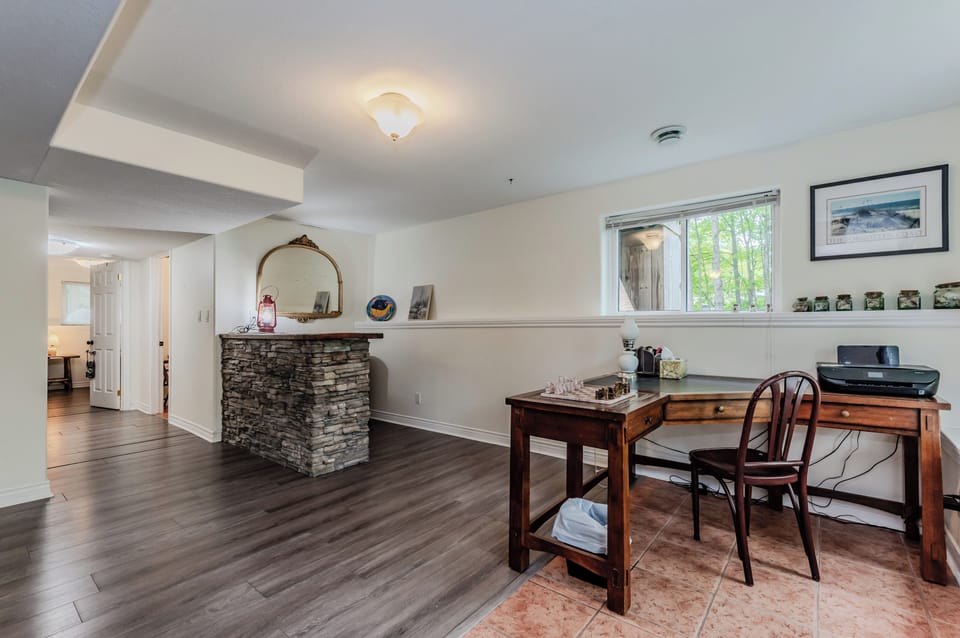 The dedicated workspace is perfect for catching up on emails or planning your next adventure, with large windows offering scenic views of the surrounding greenery.