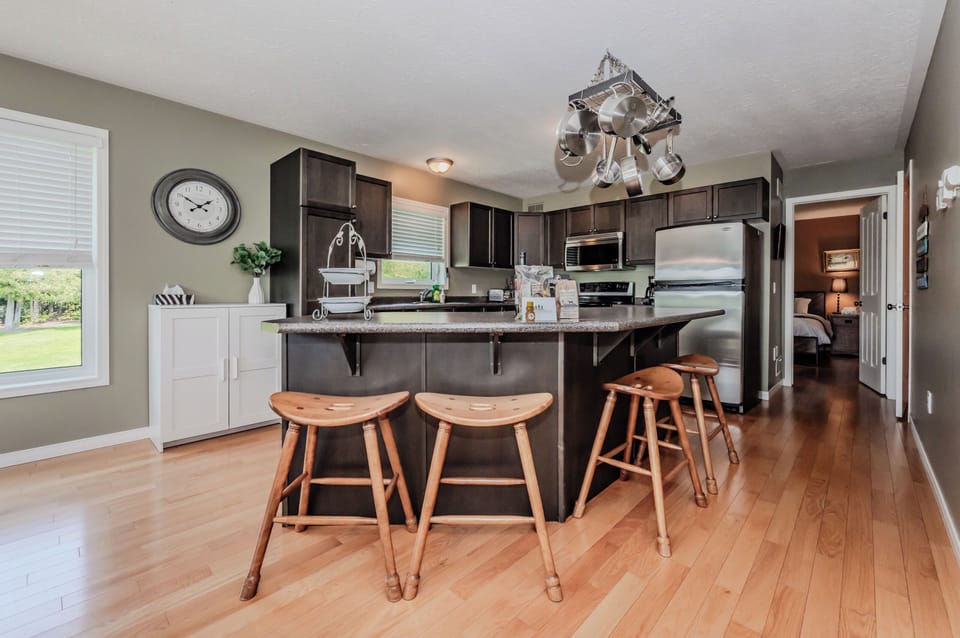Culinary Delight by the Lake: The heart of Jack's Retreat is its kitchen and dining area, a harmonious blend of modern amenities and natural lakeside views, perfect for gatherings and gourmet experiences.