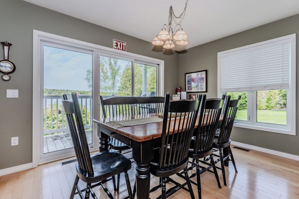 Open Spaces, Warm Places: The spacious kitchen and dining area seamlessly blend into the living space, perfect for socializing and making memories. Natural light floods in through the large windows, promising serene views while dining. 