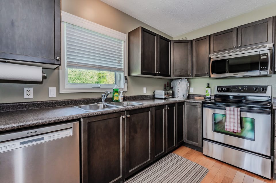 Step inside the kitchen, a gourmet space designed with modern appliances and a window-side view that makes cooking a delight. Fully stocked with cutlery and cookery.