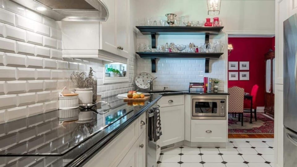 Fully equipped kitchen w/ induction cooktop, oven, stove, microwave, dishwasher.