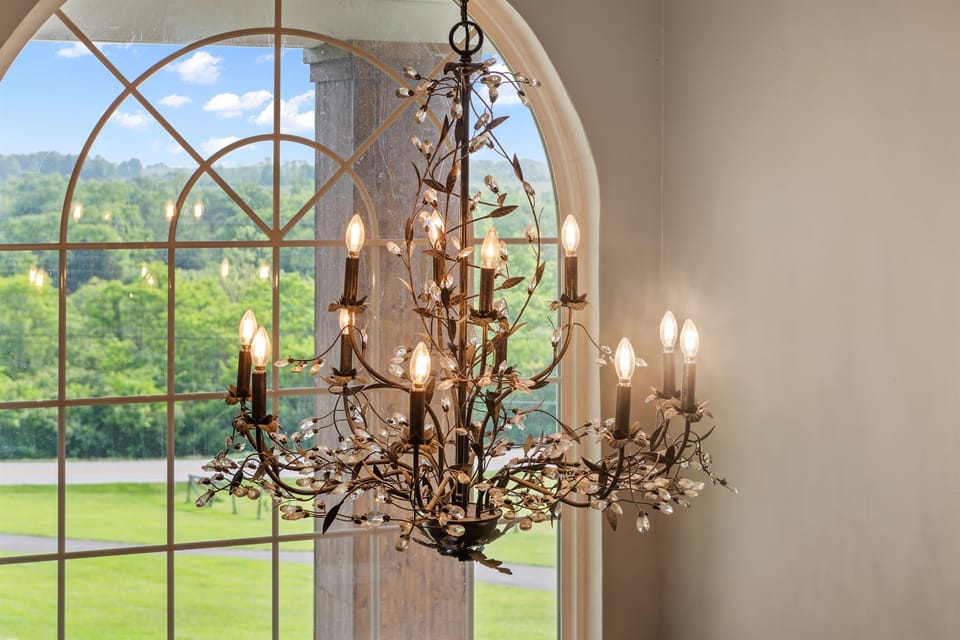 Grand entrance goals! Where crystal chandeliers meet sweeping valley views through that stunning arched window. Welcome to your slice of luxury.