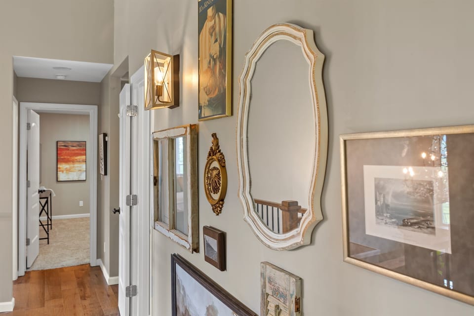 Upstairs gallery walk! Where vintage mirrors meet modern function, connecting three bedrooms and two baths. Even the hallways here tell a stylish story.