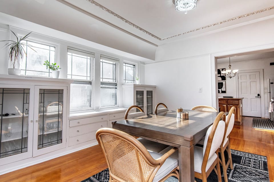 Dining table with 6 chairs. Cabinets with dinnerware, serving ware, wine glasses