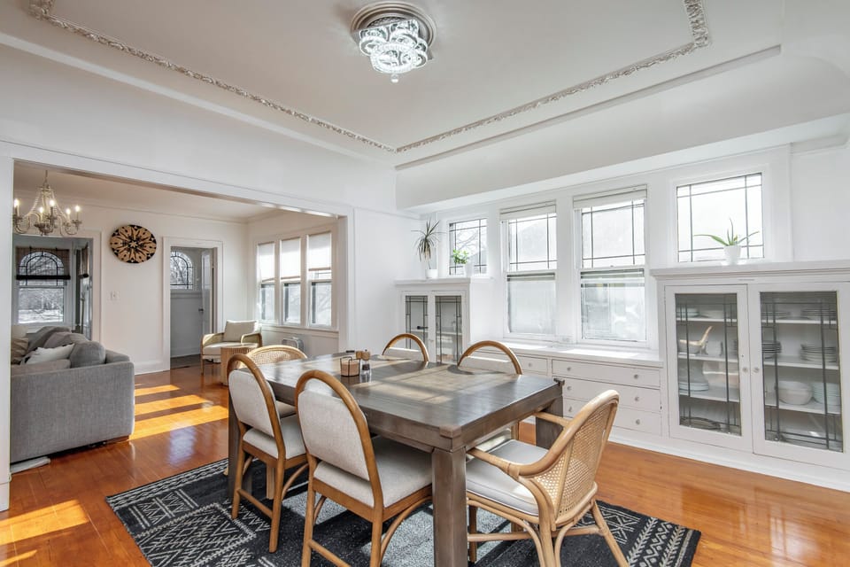 Dining table with 6 chairs. Cabinets with dinnerware, serving ware, wine glasses