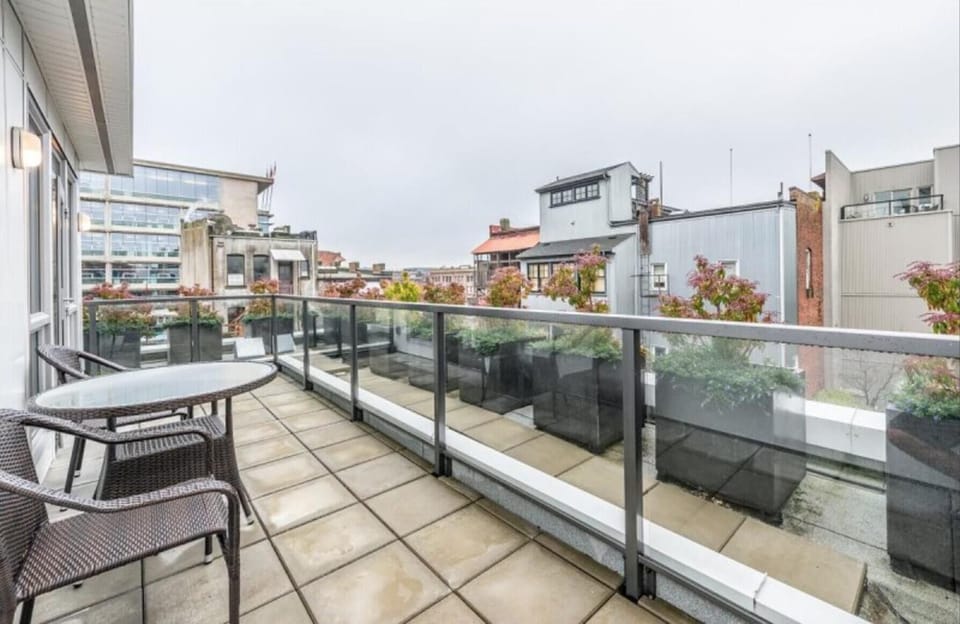 Wide view of the expansive outdoor patio space extending along the suite exterior.