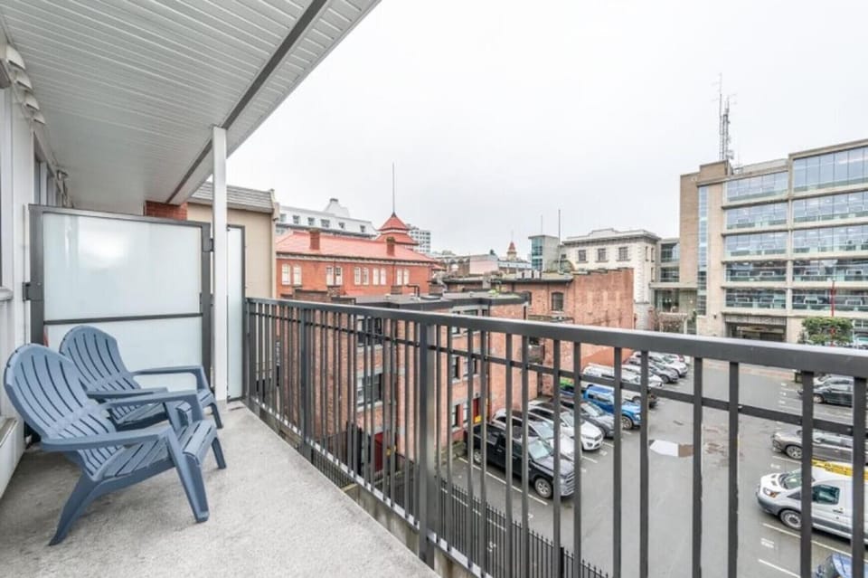 Spacious balcony with cityscape views and seating