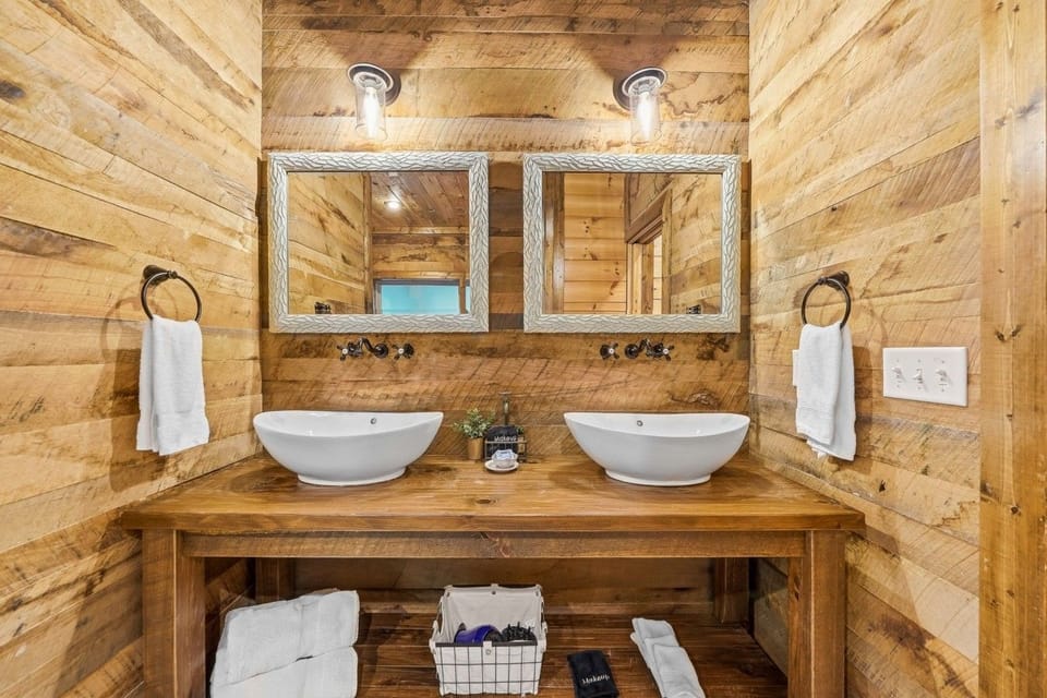 Bathroom with double vanity and two vessel sinks.