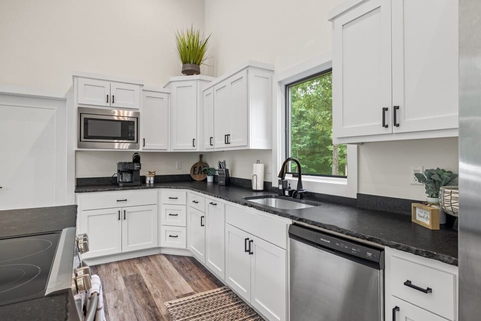 Modern kitchen with ample counter space and full cookware.