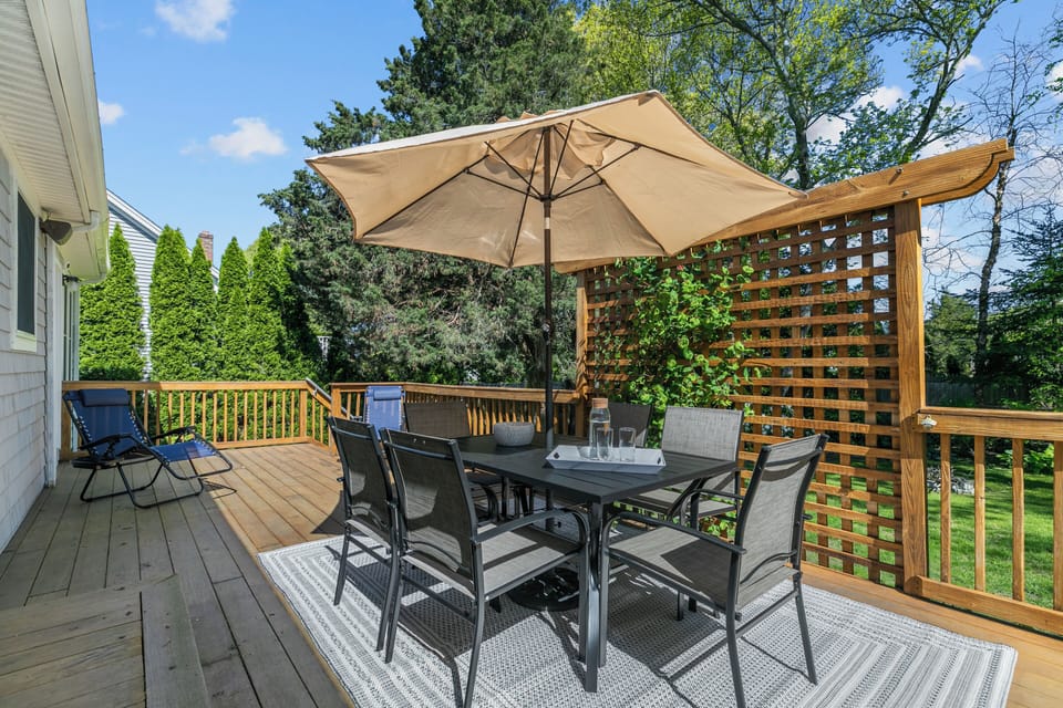 Back Deck with table, six chairs, and two lounge chairs