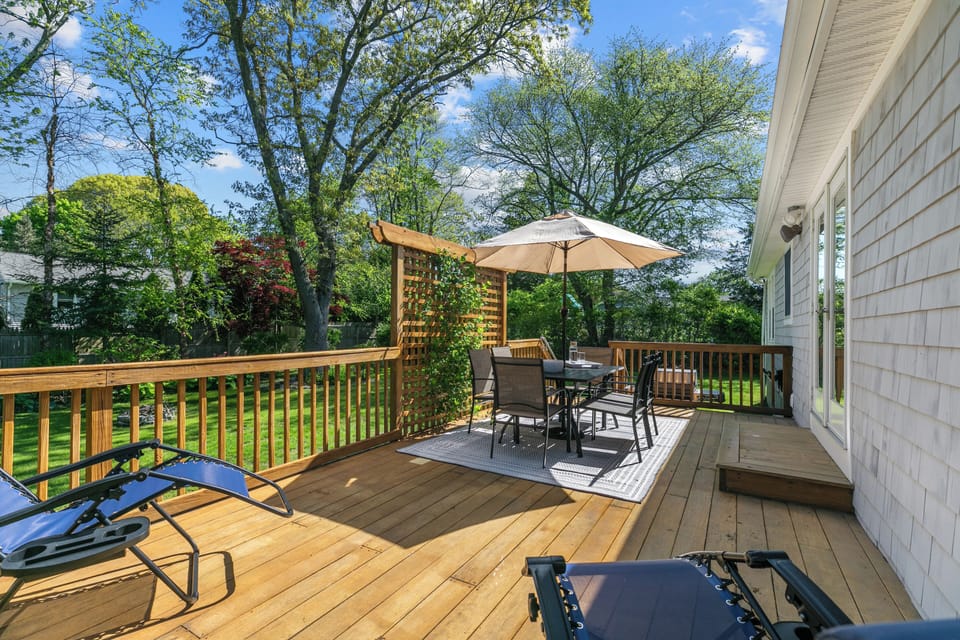 Back Deck with table, six chairs, and two lounge chairs