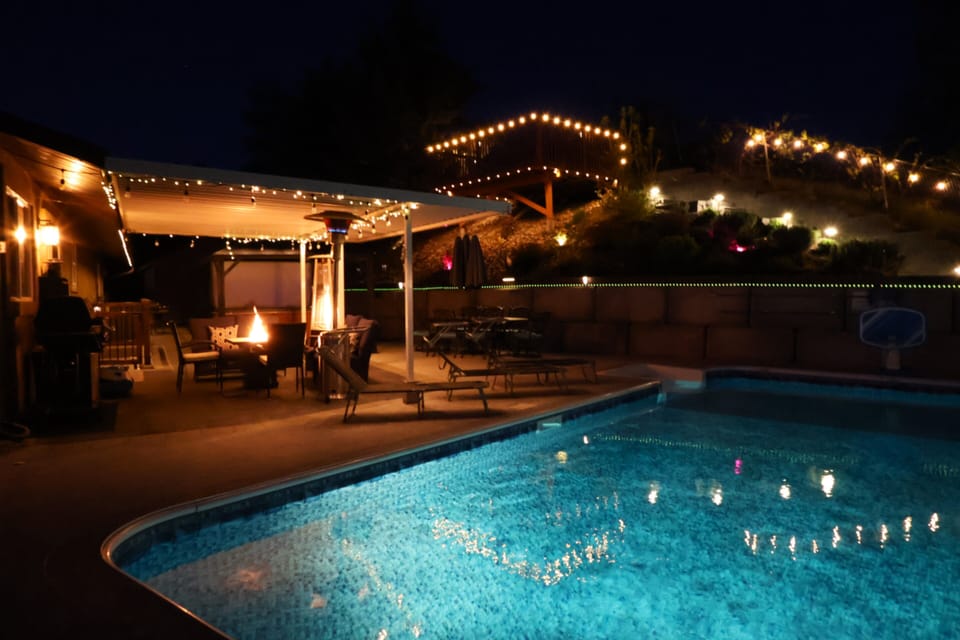 Patio heaters and landscape lighting for a cozy ambiance.