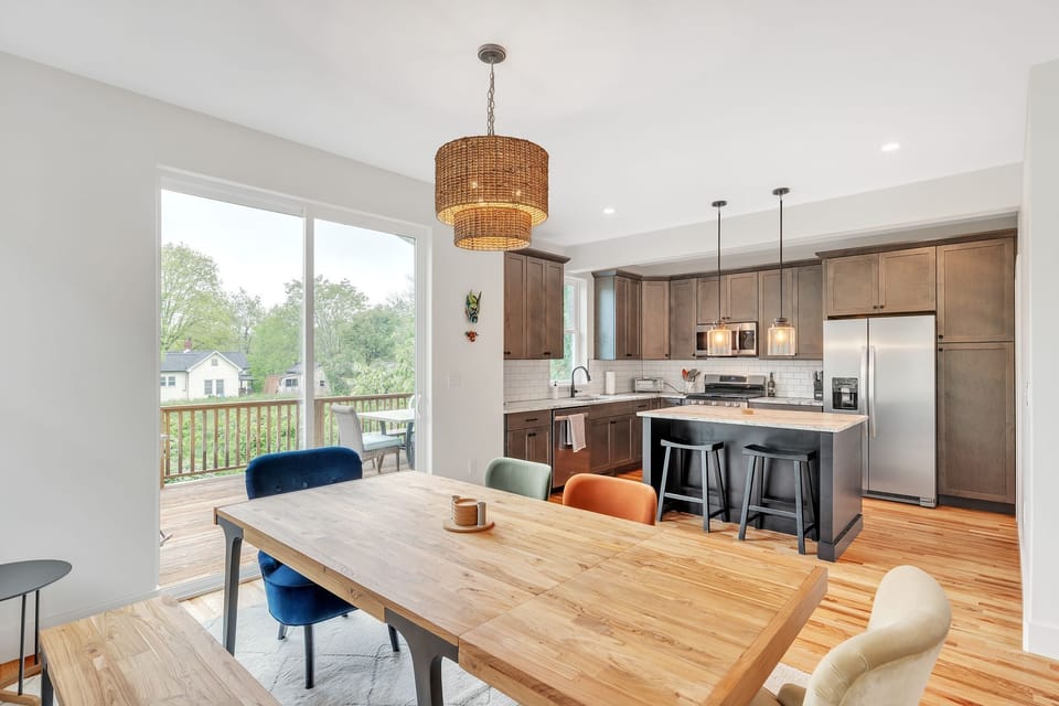 Modern appliances and lots of storage in the  fully equipped kitchen open to the dining space where you can enjoy meals with your loved ones. Direct access to the deck with outdoor seating and a grill.