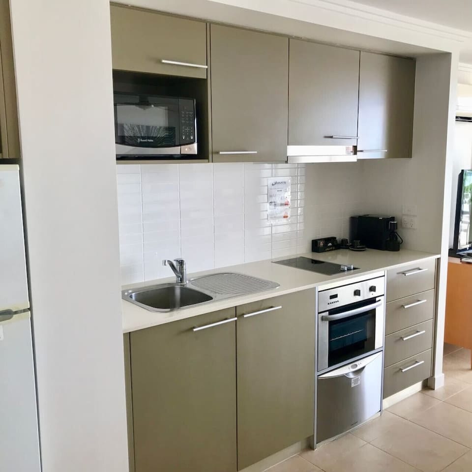 Compact, fully equipped kitchen station and basic essentials for easy meals.