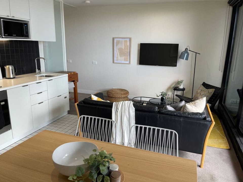 Modern open-plan living area with comfortable seating and fully equipped kitchen