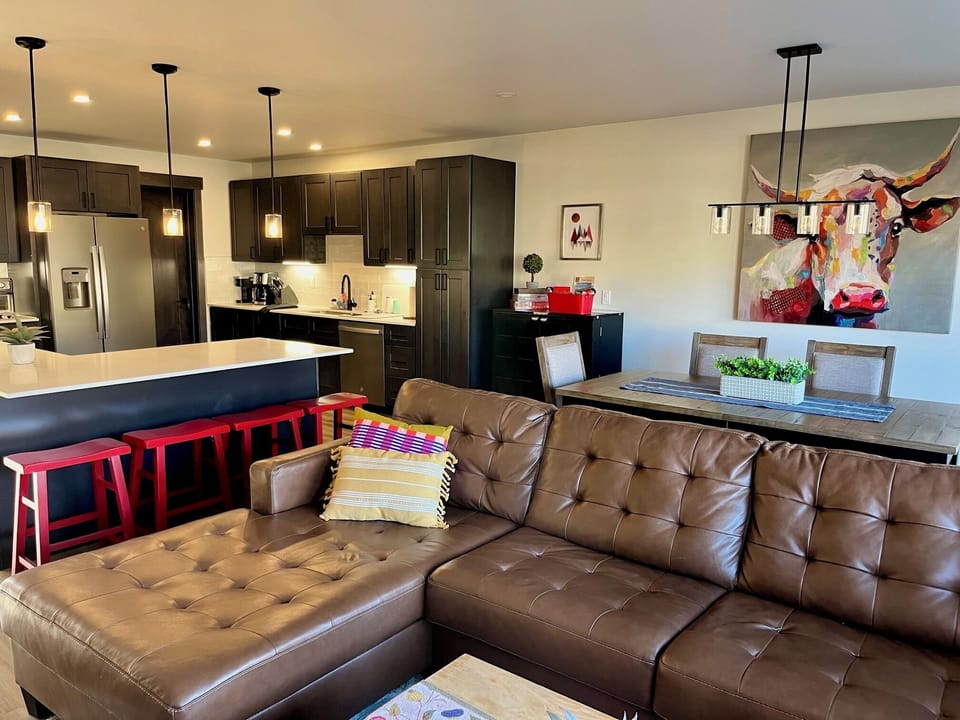 Living area, kitchen, counter eating area and dining area.