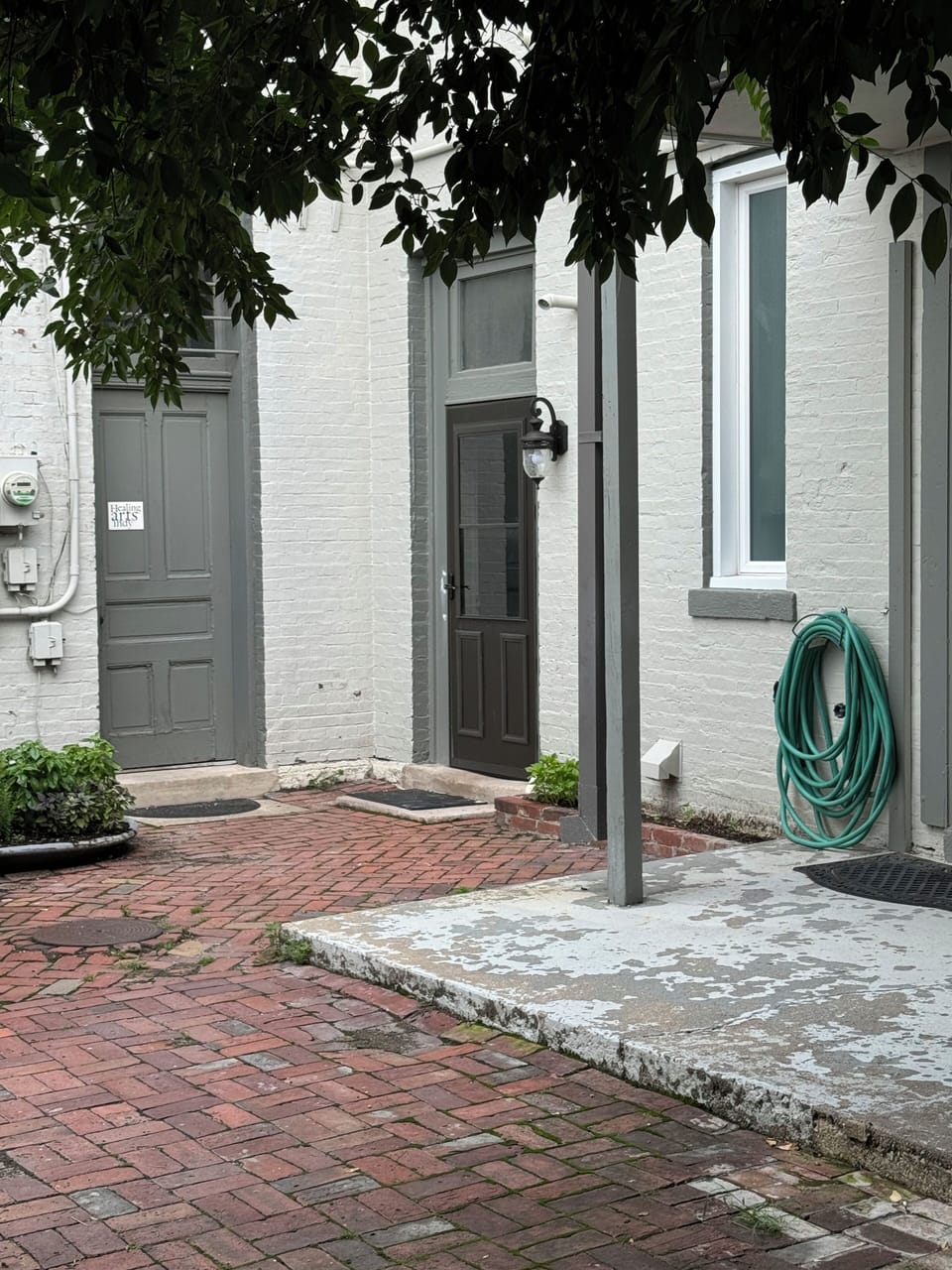 Enter through the corner door to the right of the sign that says healing arts.