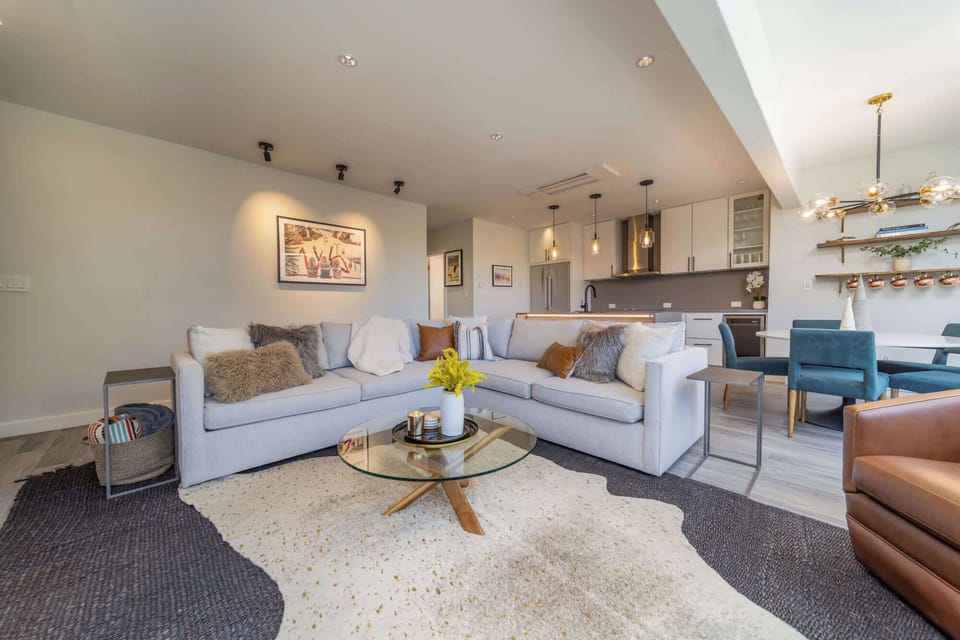 Spacious living area with oversized couch and arm chairs