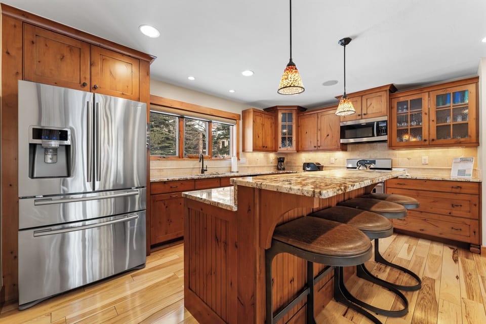 Full size kitchen featuring stainless steel appliances and granite countertops.