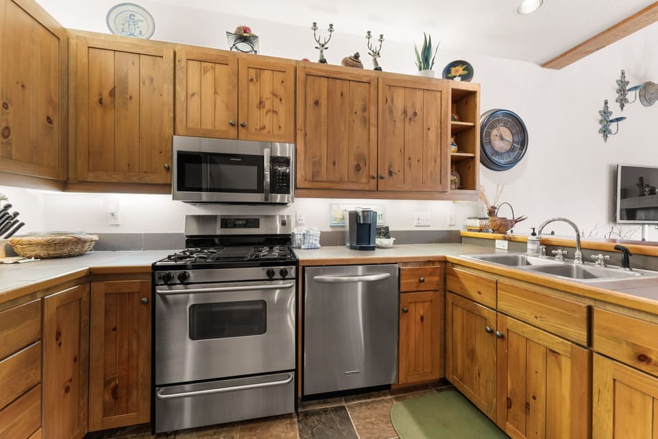 Your fully equipped kitchen features warm wood cabinets, stainless steel appliances, and everything you need to prepare delicious meals during your stay.