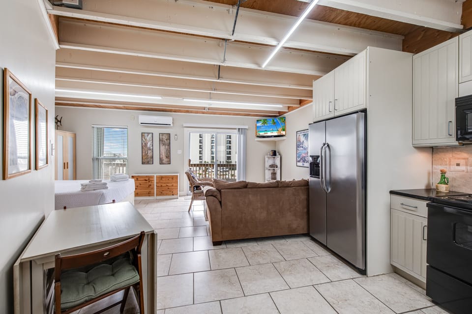Relax in your bright, open-concept space with exposed beams, full kitchen, and comfortable living area.