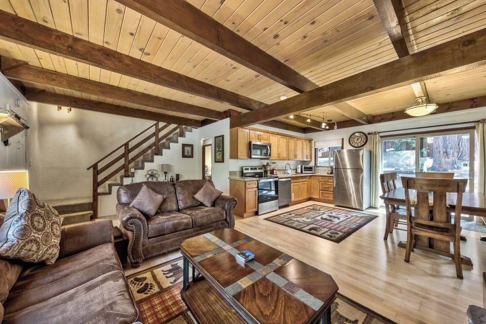 Relax in this stunning open-concept space where rustic exposed beams frame your mountain retreat. The kitchen awaits your culinary adventures.