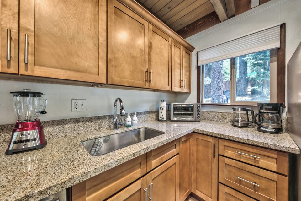 Your fully equipped kitchen features granite counters, quality appliances, and forest views for inspired meal prep.
