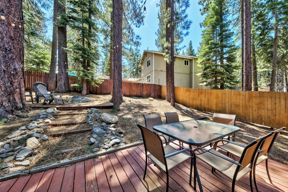 Relax on your private deck surrounded by towering pines, where morning coffee tastes better in nature's embrace.