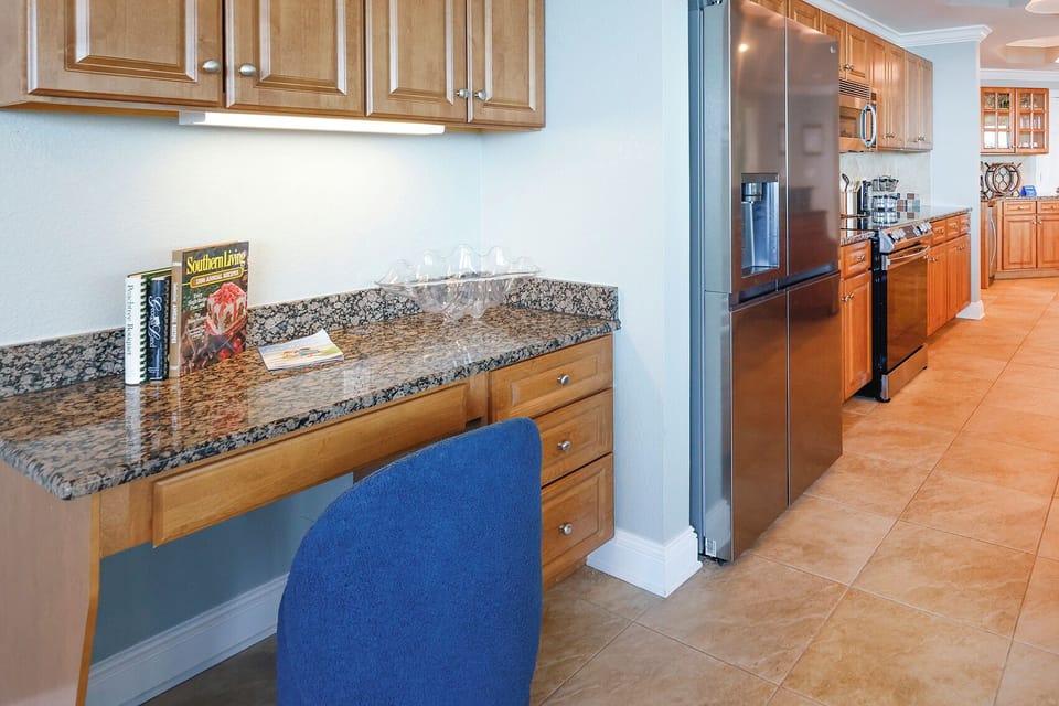 Workspace with a blue chair is featured in the kitchen area and complimentary WiFi is included during your stay