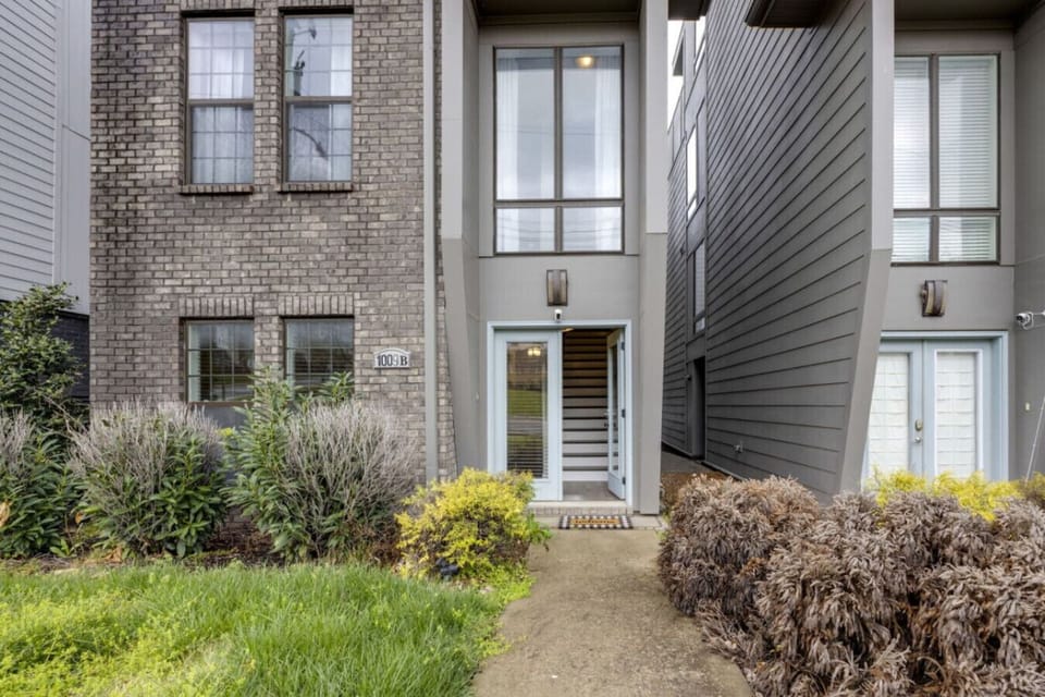 Contemporary townhome with mixed brick and modern metal siding.