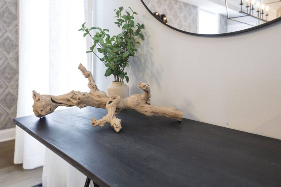 A natural driftwood piece and greenery add an organic, artful vibe.