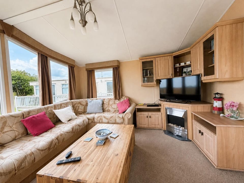 Comfortable living area with TV, Freeview, DVD player and electric fire.