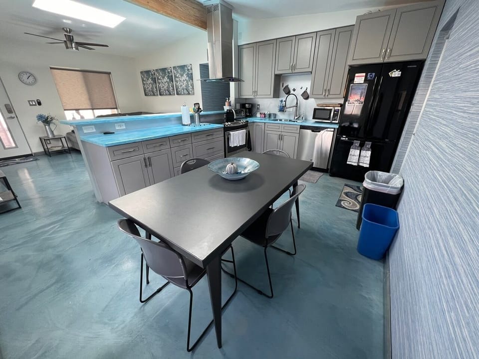 Enjoy a meal or play games around the dining room table. Seats 4 + 4 barstools!