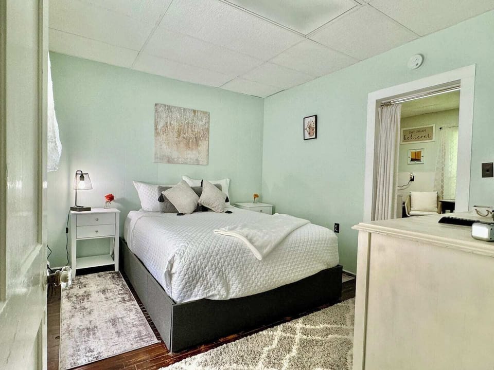 Tucked away just off the kitchen, the primary bedroom features a privacy curtain to keep your sleeping sanctuary separate from the heart of the cottage
